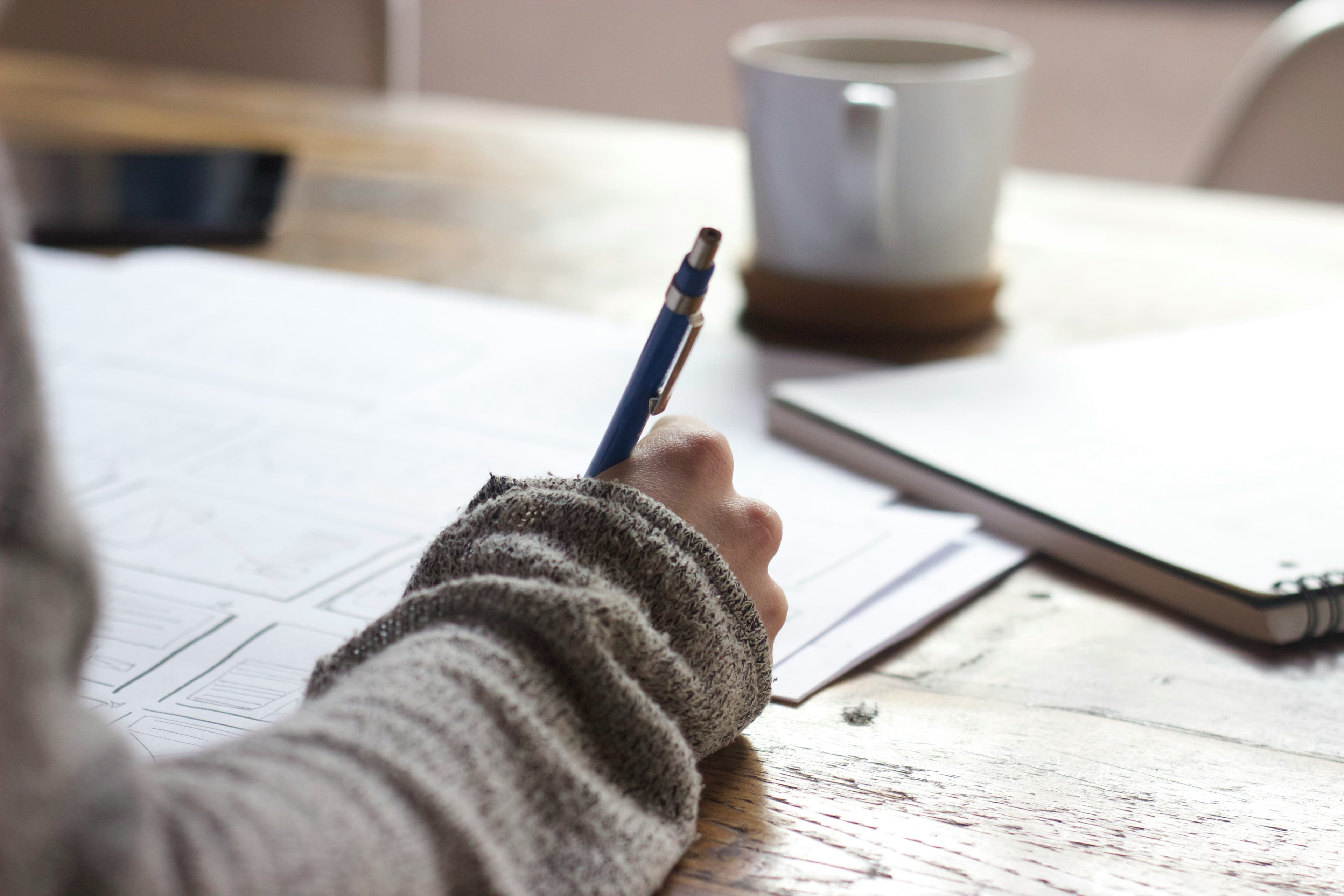 Person writing on documents